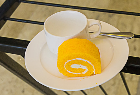 Roll cake and coffee cup empty.の写真素材