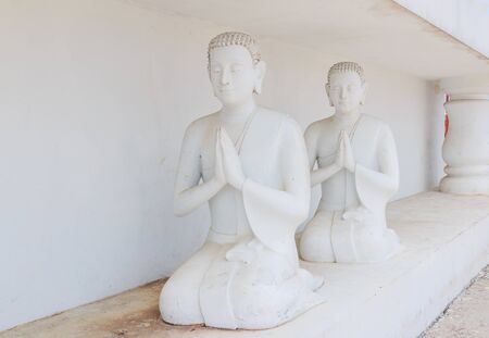 Statues of Buddhist monks in whiteの写真素材