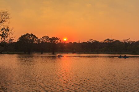 Sailing on the lake at sunsetの写真素材