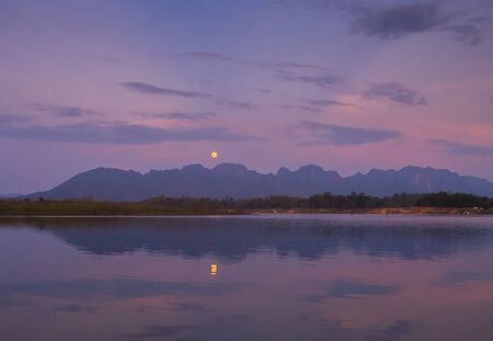 Moon and reflection of the moon at the lake.の写真素材