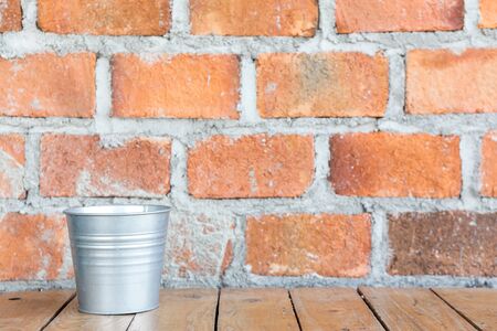 brick wall with aluminum bucketの写真素材