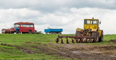 The tractor plows the land in the fields in the spring.の写真素材