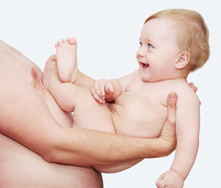 The happy child on hands at the father. On a white background.の写真素材