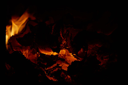 Red hot embers in a stove on a black backgroundの写真素材