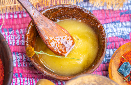 Natural honey in a wooden bowl, in a natural rural settingの写真素材