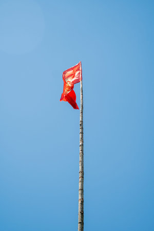 The flag of the Republic of Kyrgyzstan in the mountains.The red flag of the Republic of Kyrgyzstan...