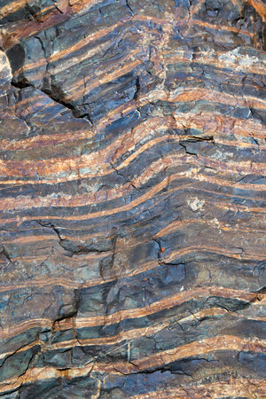 The texture of granite stone with cracks and stripes, made in various shades of brown. The stripes...