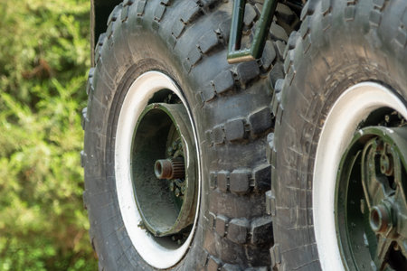 Close-up of BTR-60 armored vehicle wheels, showing massive tires, rims, and suspension elementsの写真素材