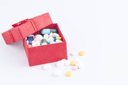 Medicine in a gift box, Colorful medicine, Medicine and capsules on over white background. With space for text yourの写真素材