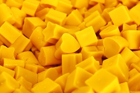 Candles shape heart and stars closeup blur background, Yellow candle waxの写真素材