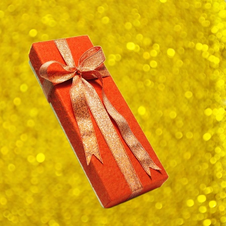 red gift box on gold backgroundの写真素材