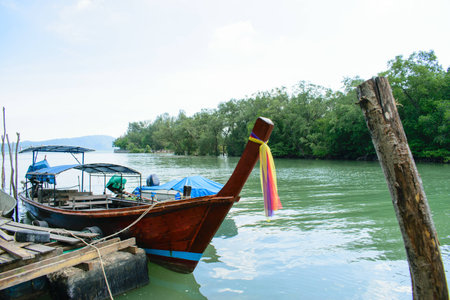 Fishing boat parked Wooden pier in a small canal.の写真素材