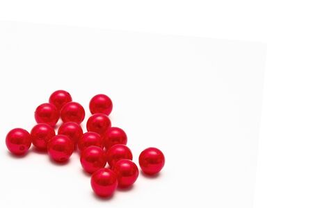 Copy space, bright red beads on a white background with space for the inscription.の写真素材