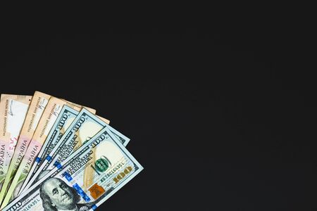 large notes dollars and hryvnia on black background. View from aboveの写真素材