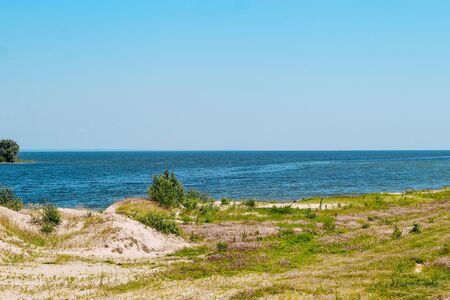 View of the river surface from the sandy shore. Skyline. landscape of the big river.の写真素材