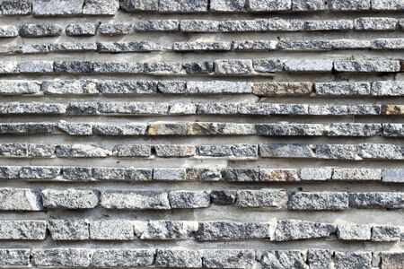 Black stone wall for background usage. Old stone wall. Imitation stone. Natural stone.の写真素材