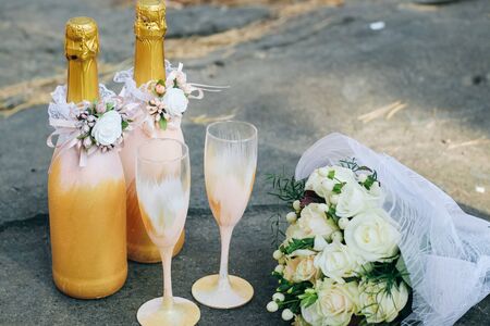 Wedding decor of champagne bottles and glasses in gold tonesの写真素材