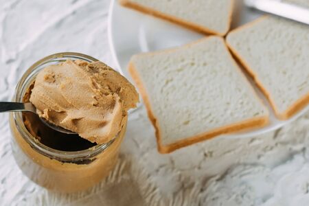 thick peanut butter in a jar close-up. Healthy eatingの写真素材
