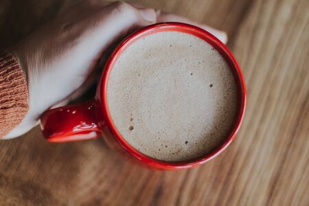 red cup with mokachino coffee in a cafe on a dark backgroundの写真素材
