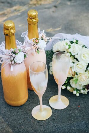 Wedding decor of champagne bottles and glasses in gold tonesの写真素材