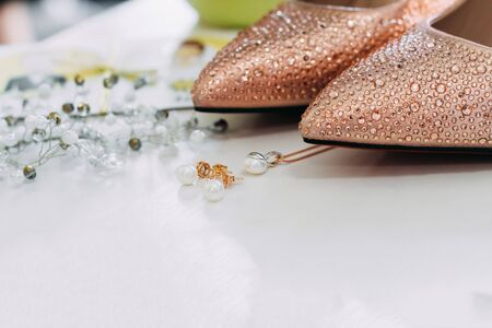 wedding details. Shoes, earrings, pendant and head jewelry nearの写真素材