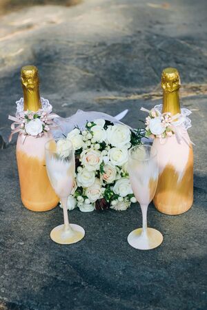 Wedding decor of champagne bottles and glasses in gold tonesの写真素材