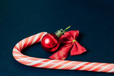 Christmas decorations, christmas ball and candy on a dark backgroundの写真素材