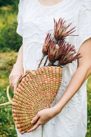 Proteus flowers in a wicker basket. Eco bag with exotic flowersの写真素材