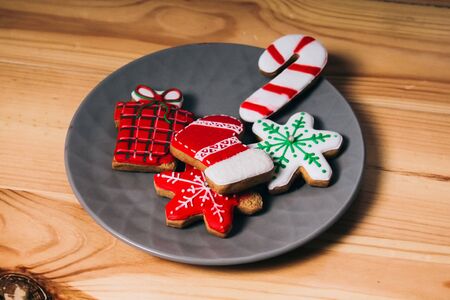 Christmas gingerbreads painted with sugar icing. Holiday cookies on cookies. Cookies in the shape of a snowflake, gift, candy, sockの写真素材