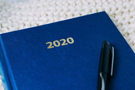 notebook with notes 2020 with pen on a white backgroundの写真素材