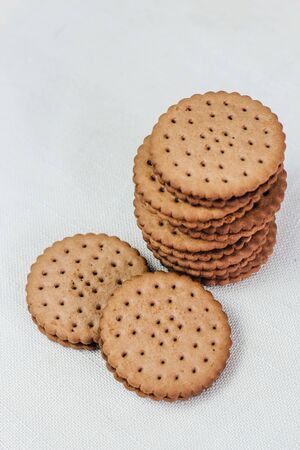 Crispy chocolate chip cookie with holes on the table. Filled Round Cookiesの写真素材