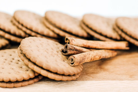 Crispy chocolate cinnamon with holes on a wooden board. Filled Round Cookies