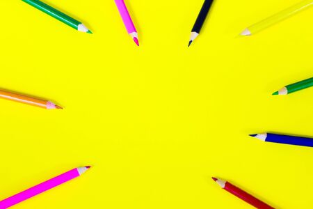color pencils on a yellow background, background for designers, space for textの写真素材