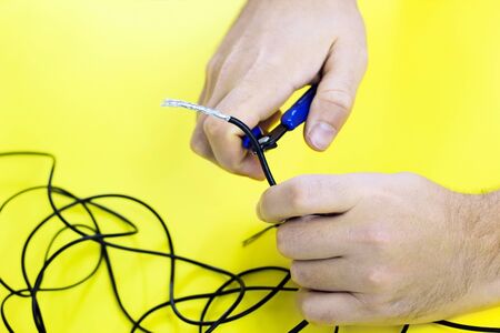 tangled charger wires. man snacks nippers black tangled wiresの写真素材