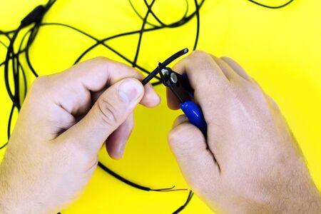 tangled charger wires. man snacks nippers black tangled wiresの写真素材