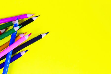 color pencils on a yellow background, background for designers, space for textの写真素材