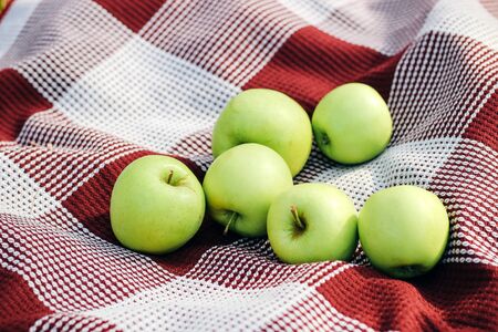 green apples on a checkered plaid. Fruit still lifeの写真素材