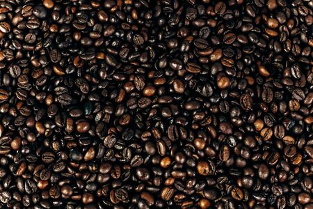 a lot of coffee beans on a wooden background. background and space for textの写真素材