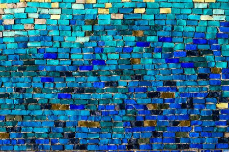 texture of multi-colored stones. Background from vintage mosaic on the wall.の写真素材
