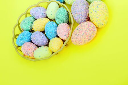 Multi-colored Easter eggs in a basket. Spring decor.の写真素材