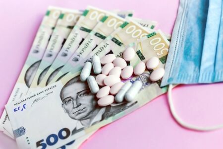 Pills, Ukrainian money and a protective medical dressing. Health concept.の写真素材