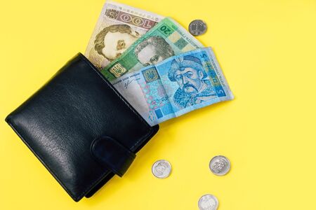 Ukrainian small money hryvnia and a penny in a leather black wallet.の写真素材