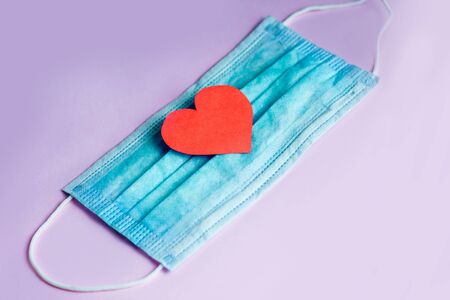 Red heart on a medical protective bandage. Concept.の写真素材