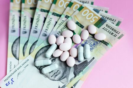 Pills and Ukrainian money are hryvnia. Concept.の写真素材