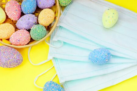 Multicolored easter eggs with medical protective mask, concept.の写真素材