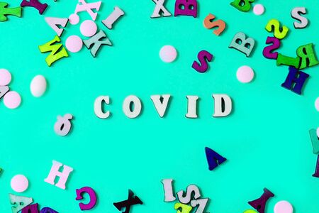 The wooden letters are the word covid. Concept on the theme of flu, virus.の写真素材