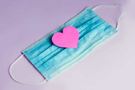 Pink paper heart on a medical protective bandage. Concept.の写真素材