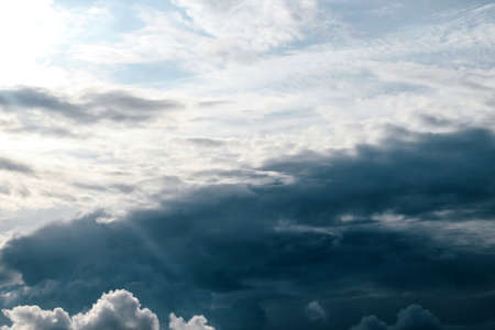 Thundercloud. The sky before bad weather. Sunbeam from behind a cloudの写真素材
