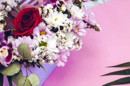 Box in the form of an envelope with a bouquet of flowers. Orchids, greenery, chrysanthemums and rose.の写真素材