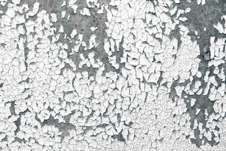 Old cracked paint texture. White paint on black surface.の写真素材